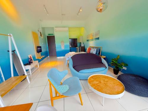 a living room with a table and some chairs at 3 Towers Jalan Ampang By Serenity Vacation Homes in Kuala Lumpur