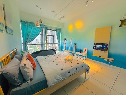 a bedroom with a bed and a television in it at 3 Towers Jalan Ampang By Serenity Vacation Homes in Kuala Lumpur