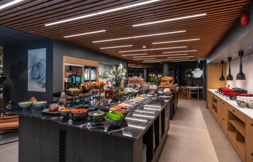 a buffet line with bowls of food on it at Thon Partner Notodden in Notodden