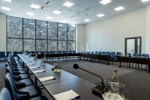 a conference room with tables and chairs and a microphone at Ani Forest Hills Hotel and Resort, Dilijan in Dilijan
