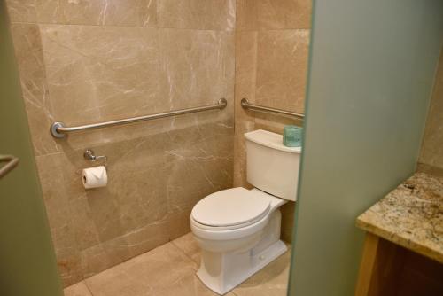 a bathroom with a white toilet and a shower at The One Boutique Hotel in Queens