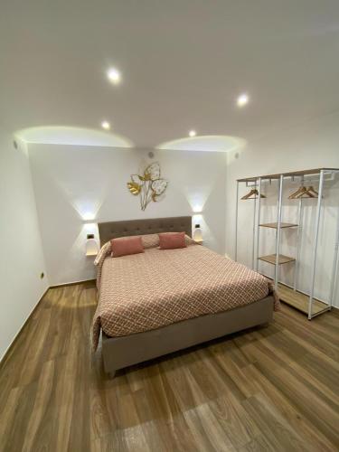 a bedroom with a bed and a butterfly on the wall at La casa di nonna chella in Bari