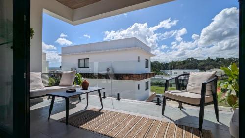 a balcony with two chairs and a table on a patio at Mountain View Penthouse Condo in Muñoz