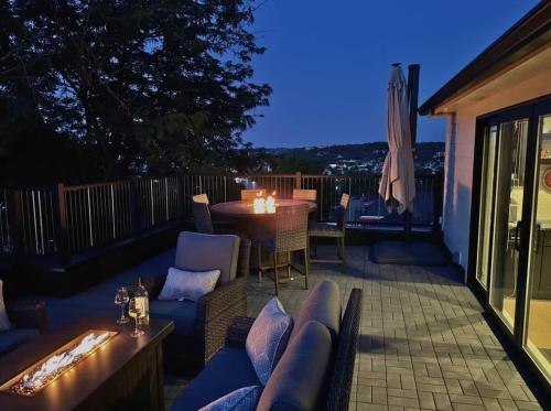 a patio with a blue couch and chairs and a table at Mt Adams Adventure in Cincinnati