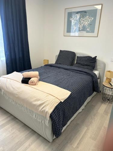 une chambre avec un lit avec une couverture noire et blanche dans l'établissement Appartement deux chambres centre ville, à Charleville-Mézières