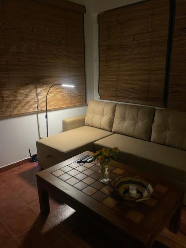 a living room with a couch and a coffee table at Beach Club Apartments in Induruwa