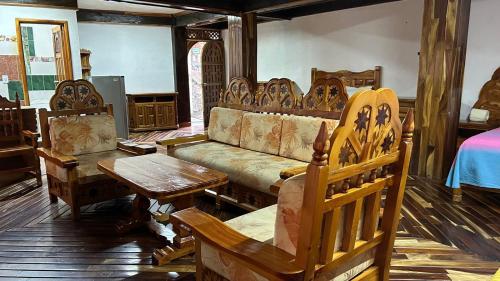 a living room with a couch and chairs and a table at Hotel Colonial Taxco in Taxco de Alarcón