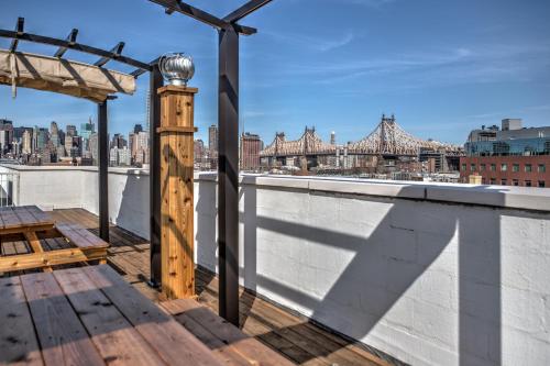 a rooftop deck with a view of the city at LIC Hotel in Queens