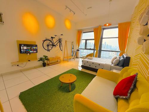 a living room with a couch and a bike on the wall at 3 Towers Jalan Ampang By Serenity Vacation Homes in Kuala Lumpur