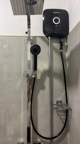 a blow dryer on a wall with a hose at Beach Club Apartments in Induruwa