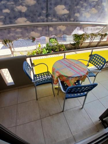 a table and chairs sitting on a balcony at Octopus in Vasiliki