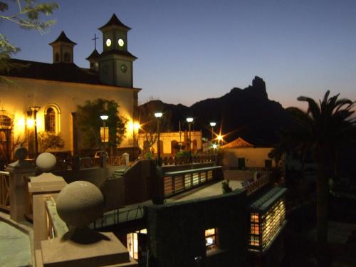 a view of a building with a clock tower at night at HOTEL FONDA de La TEA in Tejeda