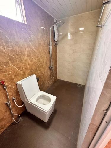 a bathroom with a toilet and a shower at Holiday Villa in Trincomalee