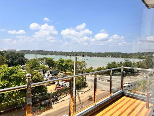 a balcony with a view of a city and a river at Holiday Villa in Trincomalee
