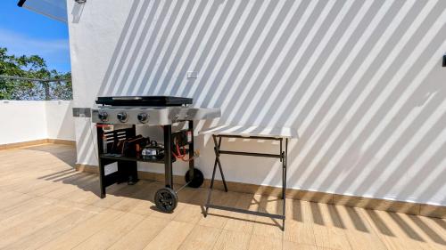 a stove and a stool next to a white wall at Mountain View Penthouse Condo in Muñoz