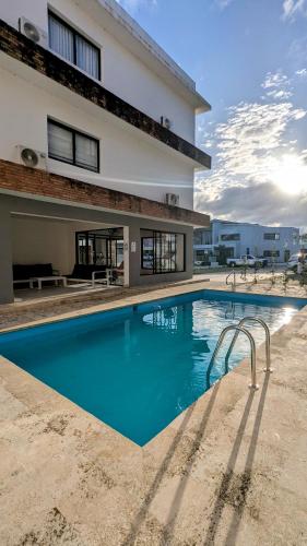 a large swimming pool in front of a building at Mountain View Penthouse Condo in Muñoz