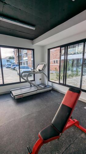 a red chair in a room with windows at Mountain View Penthouse Condo in Muñoz