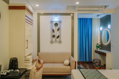 a living room with a couch and a table at Excellency Airport Hotel in Angamali