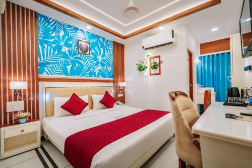 a hotel room with a bed and a desk at Excellency Airport Hotel in Angamali
