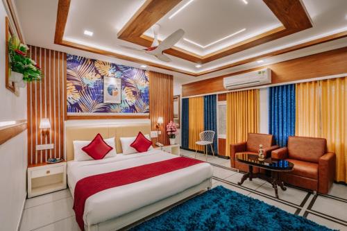 a hotel room with a bed and a chair at Excellency Airport Hotel in Angamali