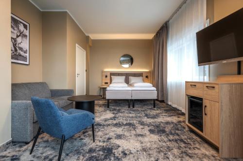 a hotel room with a bed and a television at Thon Partner Notodden in Notodden