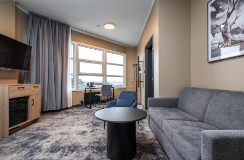 a living room with a couch and a table at Thon Partner Notodden in Notodden