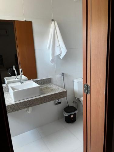a bathroom with a sink and a toilet at Casa Tororão - Arraial d'Ajuda in Porto Seguro