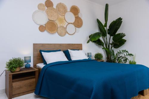 a bedroom with a bed with a blue blanket at Hillside Studio with Sea View & Fibre Internet in Albufeira