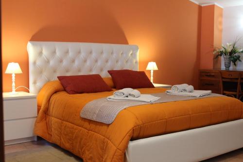 a bedroom with a large bed with towels on it at Bed and Breakfast Dello Stretto in Villa San Giovanni