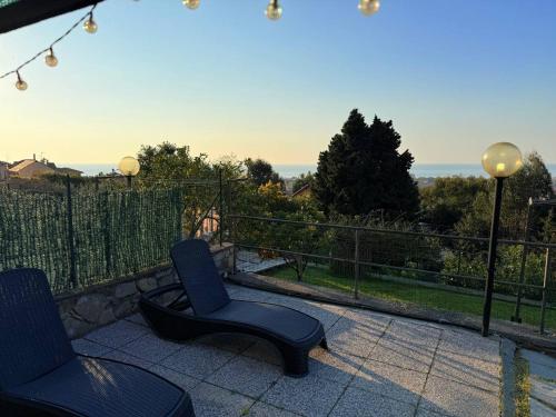 a pair of chairs sitting on a patio with a view at Sea Garden in San Bartolomeo al Mare