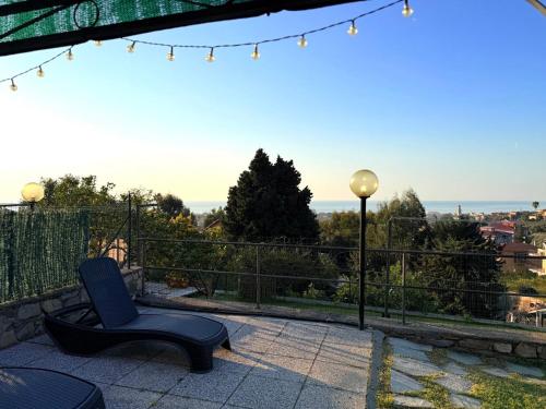 a patio with a chair and a view of the ocean at Sea Garden in San Bartolomeo al Mare