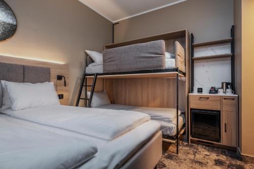a room with two bunk beds and a desk at Thon Partner Notodden in Notodden