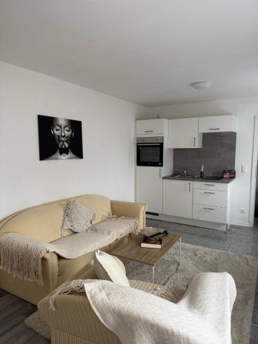 a living room with a couch and a table at Appartementshaus Vlora in Bad Füssing