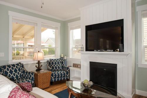 a living room with a fireplace with a flat screen tv at A Bit of R n R in Lincoln City