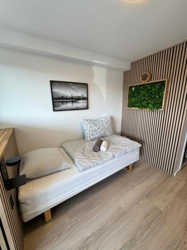 a bed in a room with a picture on the wall at City Aarhus in Aarhus