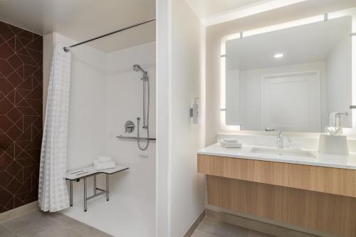 a bathroom with a sink and a mirror at Homewood Suites By Hilton Thornton Denver in Thornton