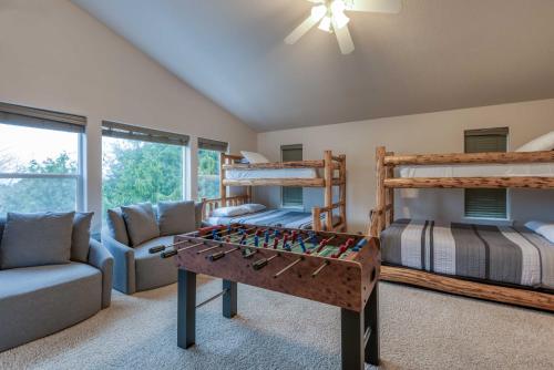 a bedroom with bunk beds and a foosball table at A Lobster Lookout in Lincoln City