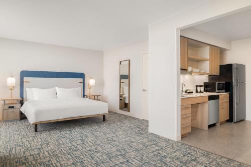 a large bedroom with a bed and a kitchen at Homewood Suites By Hilton Thornton Denver in Thornton
