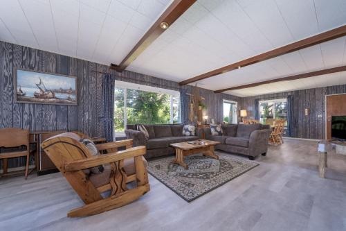 a living room with a couch and a table at Ebbing House in Lincoln City