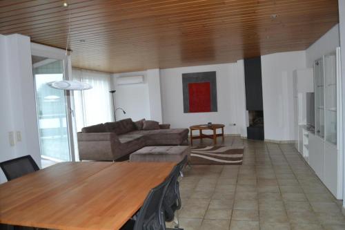 a living room with a couch and a table at PentArtHouse in Burscheid
