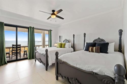 two beds in a bedroom with a view of the ocean at Villa Isla Azul in Ocotal