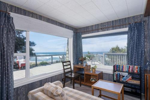 a living room with a view of the ocean at Ebbing House in Lincoln City