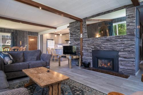 a living room with a couch and a fireplace at Ebbing House in Lincoln City