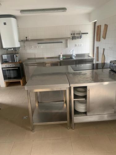 a kitchen with a stainless steel counter in a kitchen at Chalupa Adamův Dvůr in Zdíkov