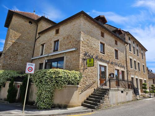 a brick building with a no parking sign in front of it at Le Val d'Amby in Hières-sur-Amby