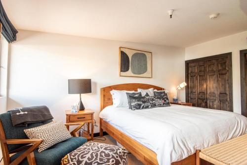 a bedroom with a bed and a chair at Christophe Condo 712 in Ketchum