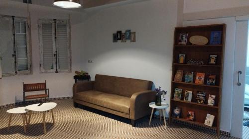 a living room with a couch and two tables at Cuarto Antolín Yellowdoor in Ponferrada
