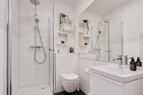 Jugendstil-Altbauwohnung an der Karlsaue - 120qm, Klimaanlage, neu saniert, zentrale Lage في كاسيل: حمام ابيض مع دش ومرحاض ومغسلة