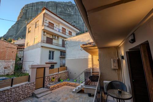 a balcony with a table and a building at Villa KONTOULIS in Kalabaka