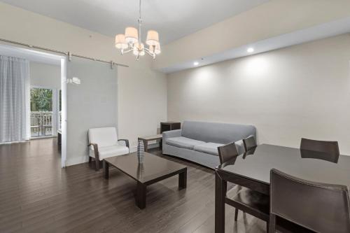a living room with a couch and a table and chairs at Provident Doral At The Blue in Miami